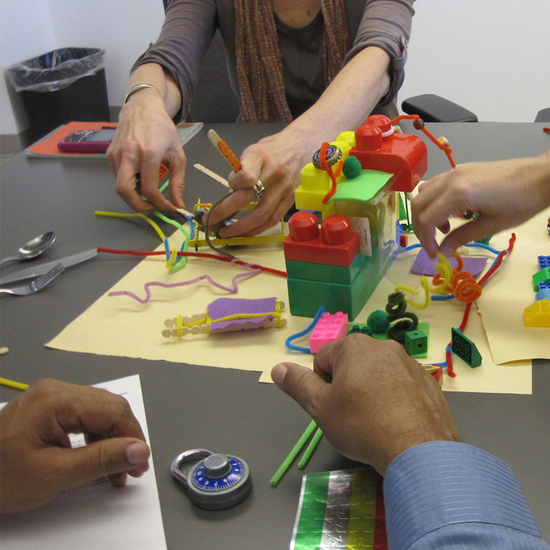 Students creating urban landscapes using found materials and a 