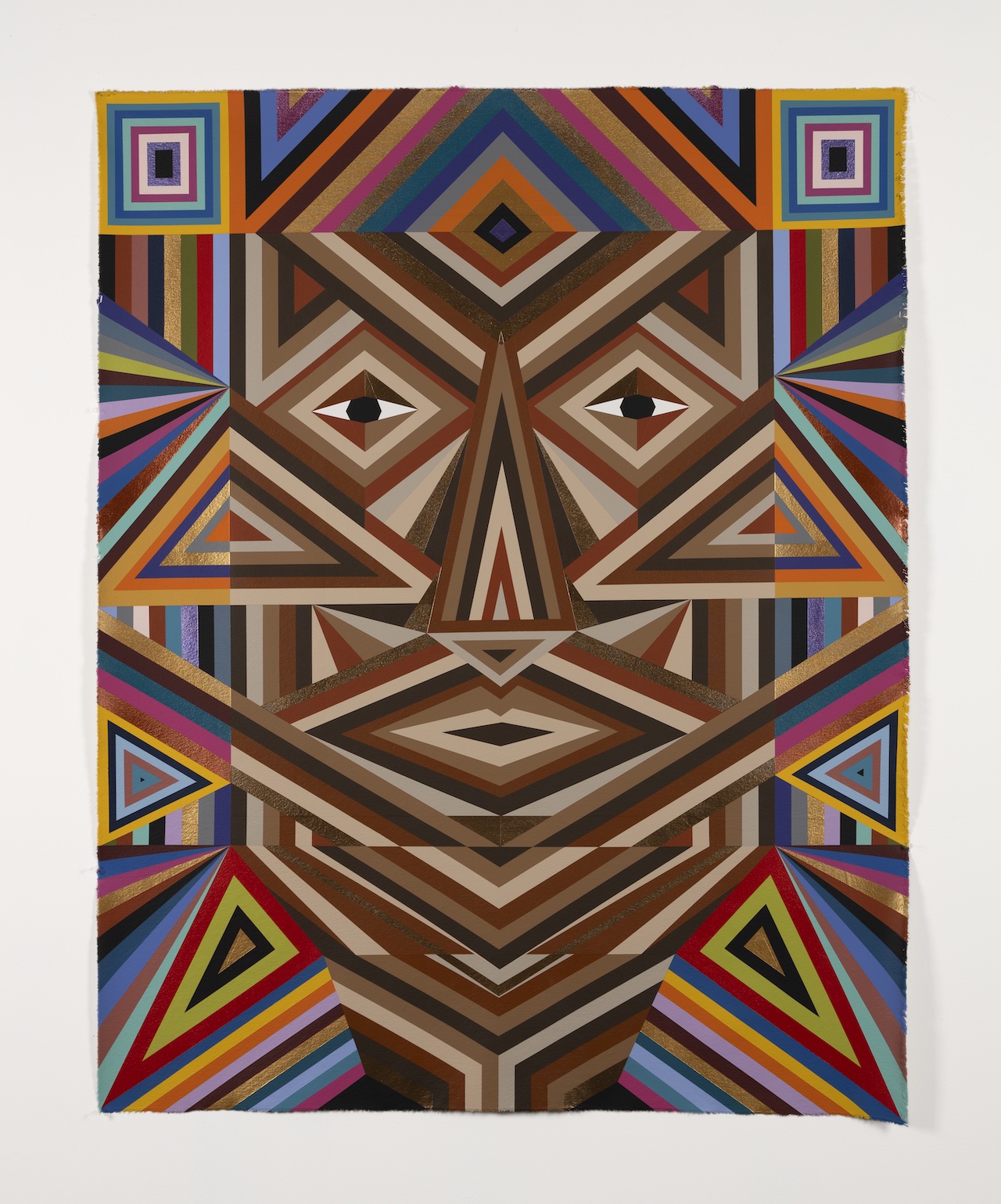 A geometric and abstract painting with a symmetrical face-like design. The artwork consists of various colorful, intersecting lines and shapes, forming a complex pattern. The colors include shades of brown, blue, orange, and purple, creating a visually striking and intricate composition.